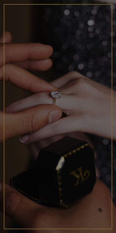 Man putting engagement ring on womans finger