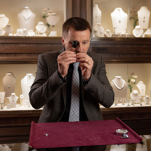 Jeweller inspecting a diamond ring